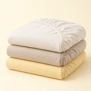 Folded neutral fitted cot sheets